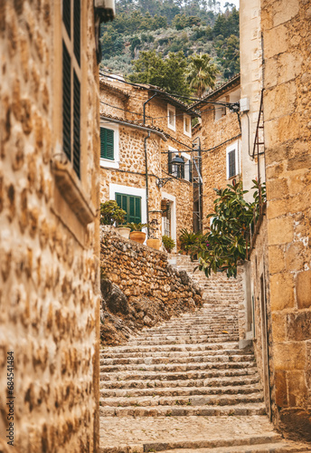 Fototapeta Naklejka Na Ścianę i Meble -  A charming old staircase in the cozy street of a small village Fornalutx in Mallorca