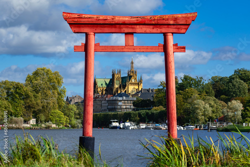 Japanese Torii gate in Metz at the plan d’eau with the Saint Stephen cathedral in the background