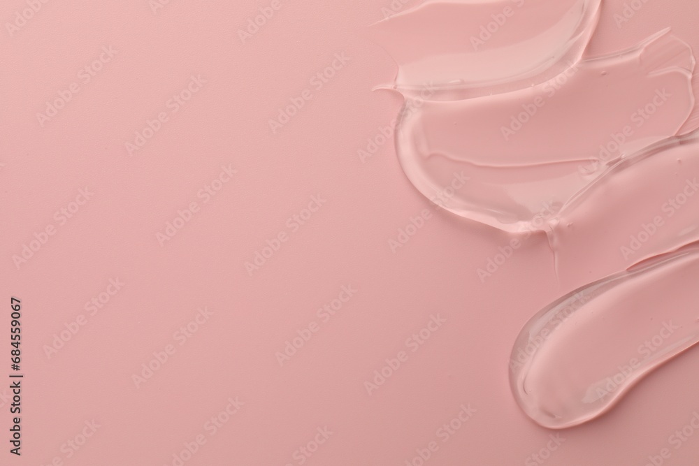 Sample of clear cosmetic gel on pink background, top view. Space for text Sample of clear cosmetic gel on pink background, top view. Space for text