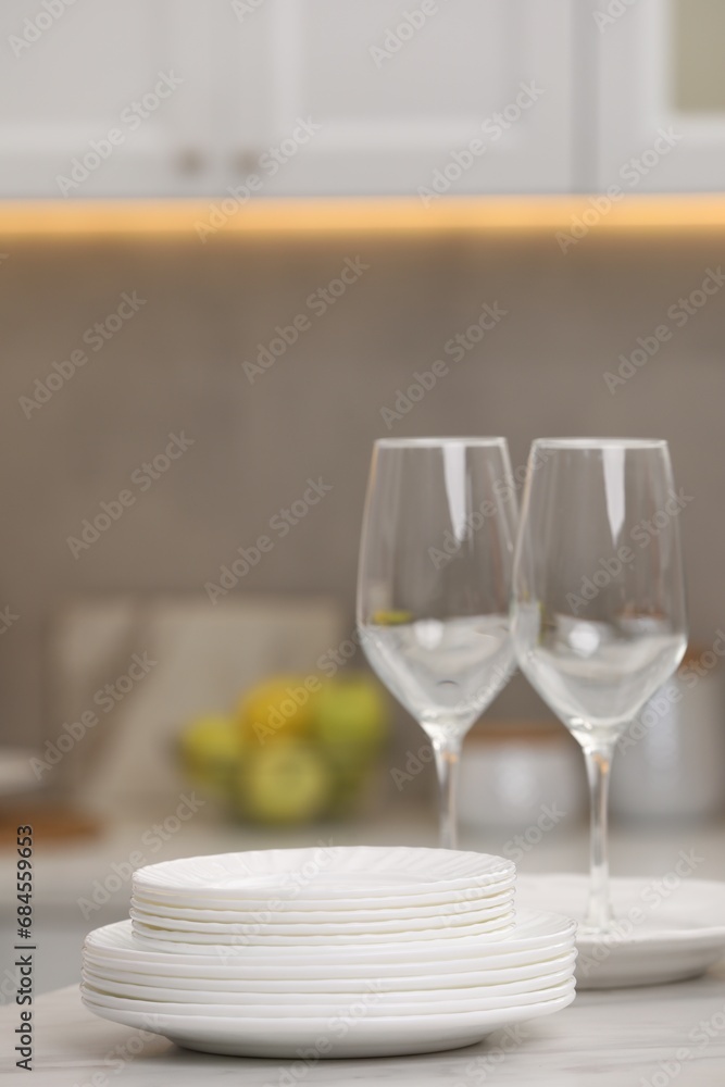 Clean dishes on light table in kitchen, space for text Clean dishes on light table in kitchen, space for text