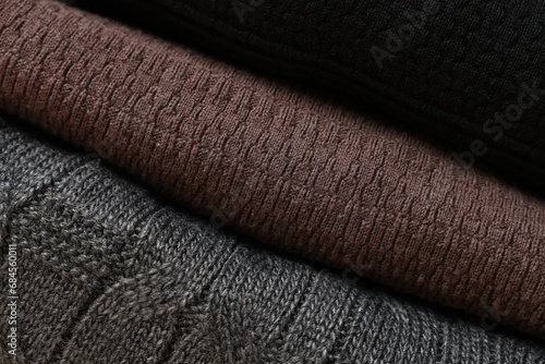 Closeup view of different casual folded sweaters as background
