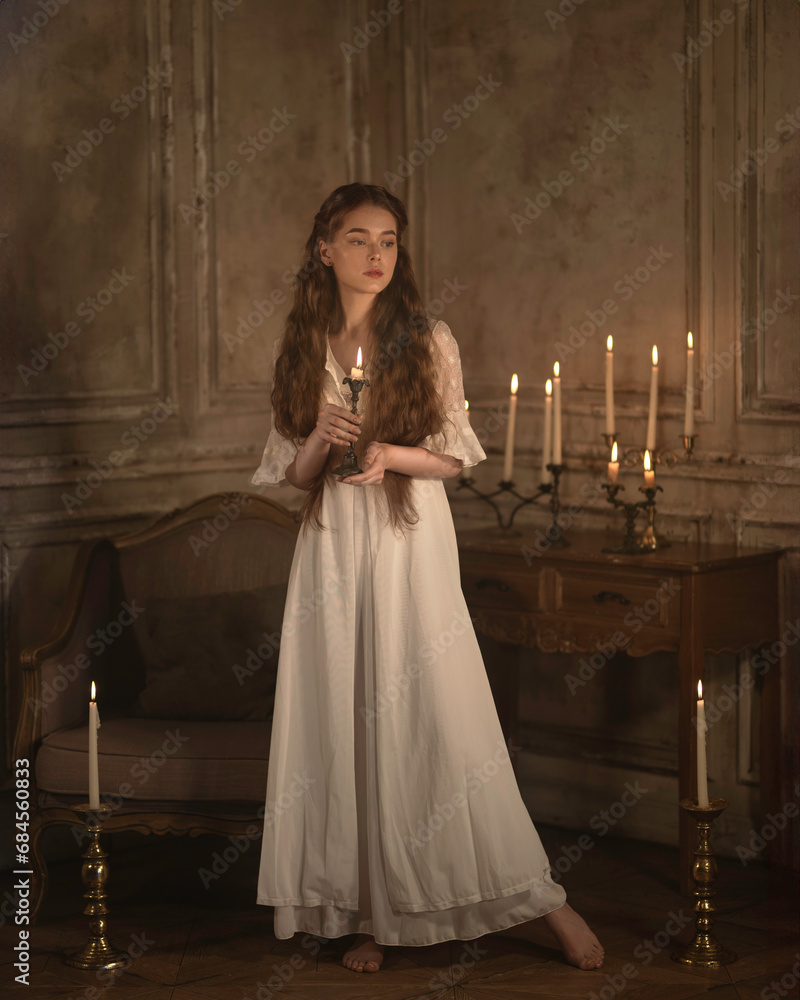 Girl in a nightgown with candles