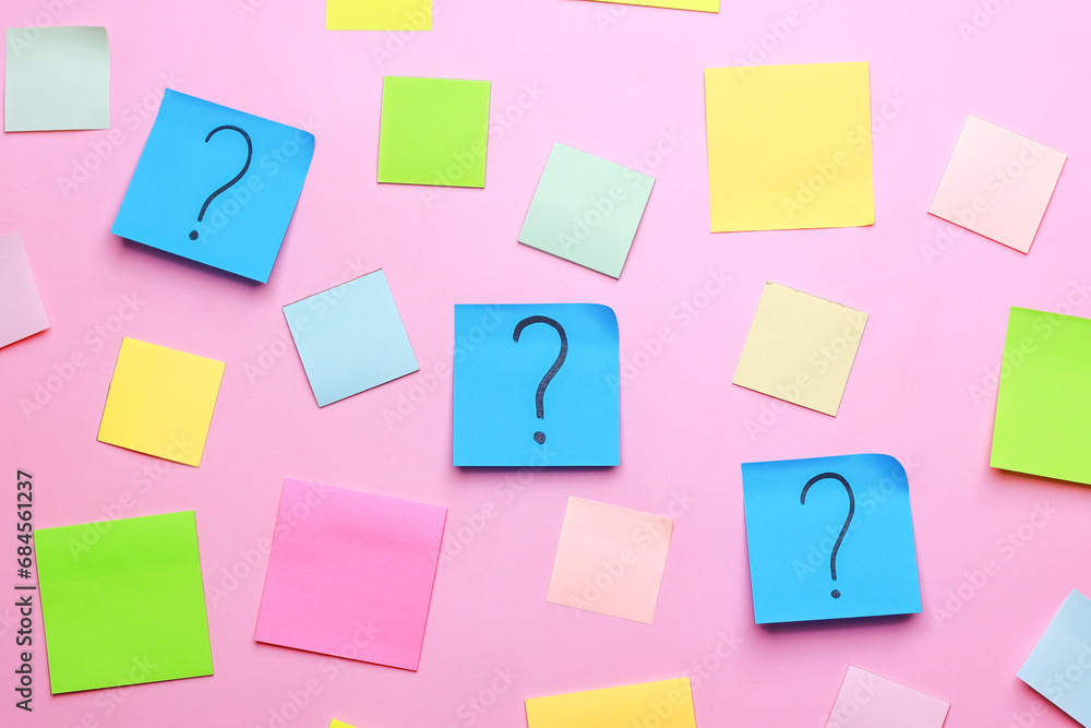 Question marks with colorful blank sticky notes on pink background Question marks with colorful blank sticky notes on pink background