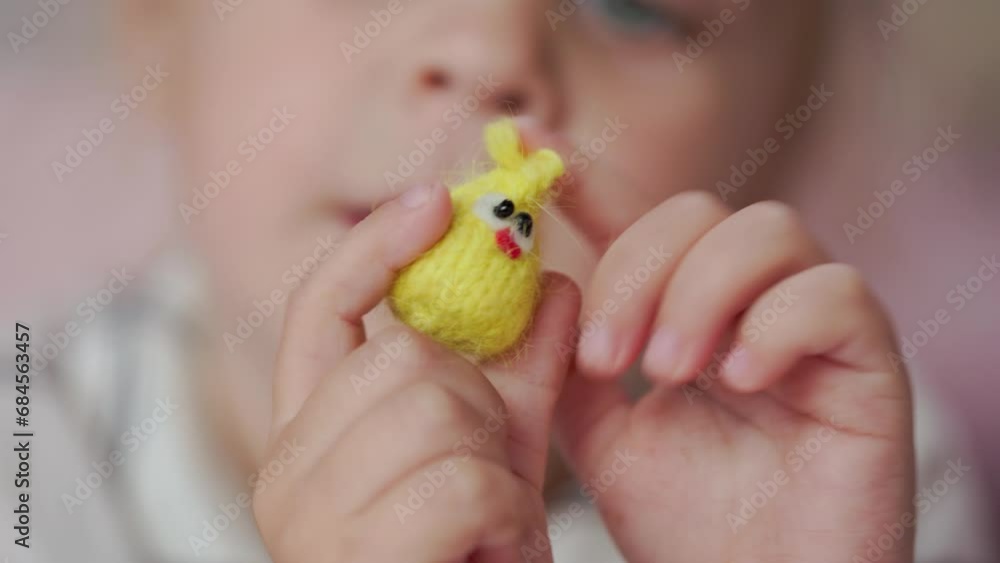 Girl child plays with small knitted animal toys in a room at home Girl child plays with small knitted animal toys in a room at home