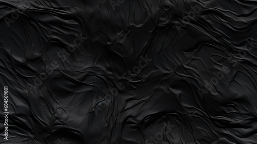 Fond d'un mur noir, texturé, avec relief. Ambiance sombre. Arrière-plan pour conception et création graphique. 