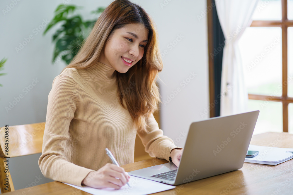 Happy beautiful Asian Woman. Business woman working from home with laptop Financial Home work space concept. Happy beautiful Asian Woman. Business woman working from home with laptop Financial Home work space concept.