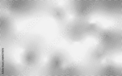 Abstract spotted halftone black effect. Monochrome texture for printing on badges, posters, and business cards. Vintage background of little dots randomly arranged