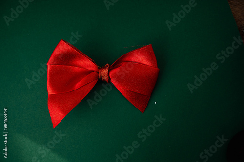 Red bow on a green background. Place for text