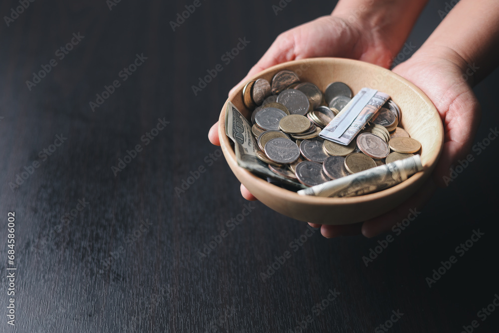 One tenth or tithe is basis on which Bible teaches us to give one tenth of first fruit to God. coins with Holy Bible. Biblical concept of Christian offering, generosity, and giving tithes in church. One tenth or tithe is basis on which Bible teaches us to give one tenth of first fruit to God. coins with Holy Bible. Biblical concept of Christian offering, generosity, and giving tithes in church.