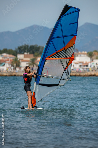 Caucasian young woman windsurfing on the Costa Brava de Roses in Girona Spain