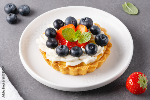 Creamy cheesecake cake with blueberry and strawberries