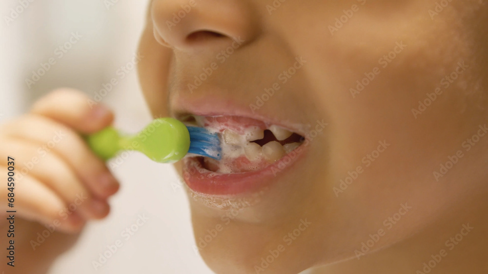 Dental hygiene. Child boy brushing his teeth in the bathroom. Close up. High quality photo Dental hygiene. Child boy brushing his teeth in the bathroom. Close up. High quality photo