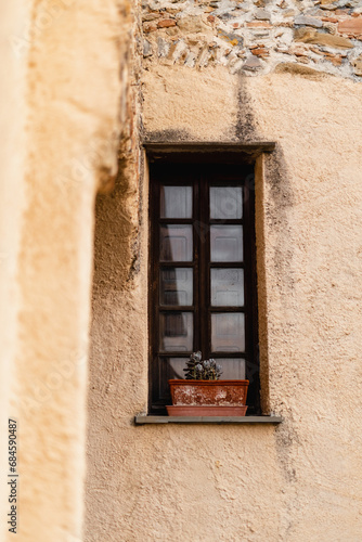 Fragment of the facade of a medieval building - expensive maintenance of an ancient stone house