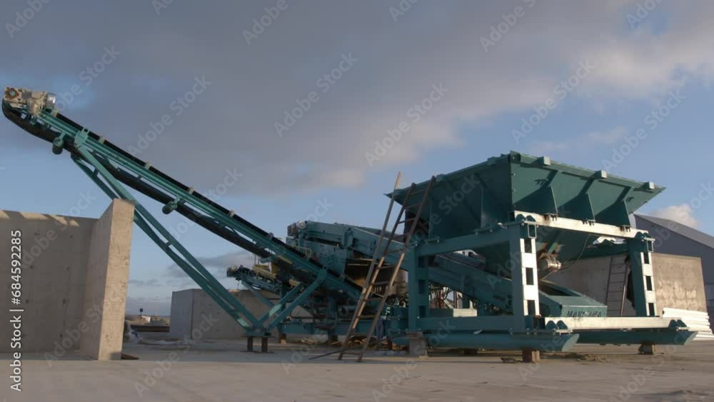 Employee works on versatile machines capable of separating variety of materials. Worker operates on machinery with ability segregating materials