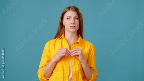Young woman bites nails consumed with anxious thoughts