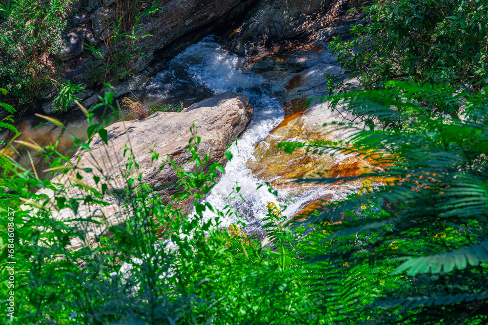 beautiful cascading waterfall over rocks long exposure in Chiangmai Chiang mai mountains northern thailand amongst lush green tropical rainforest beautiful cascading waterfall over rocks long exposure in Chiangmai Chiang mai mountains northern thailand amongst lush green tropical rainforest