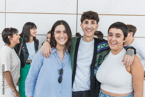 Group of cheerful multiethnic friends standing together outdoors