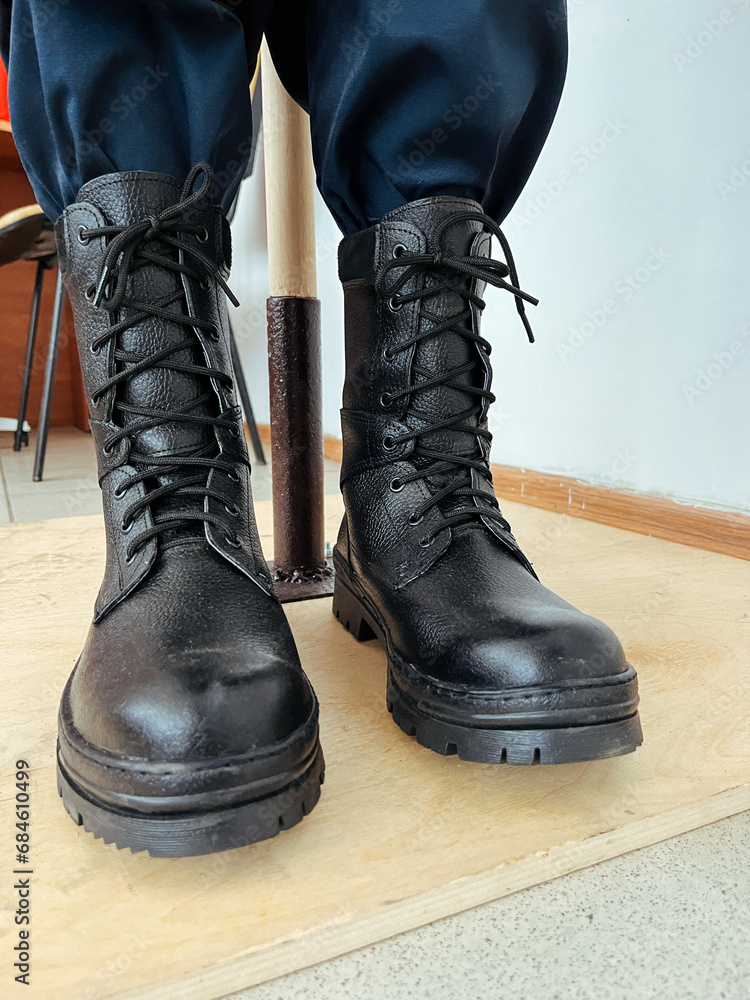 Military boots on the legs of soldiers in a row.