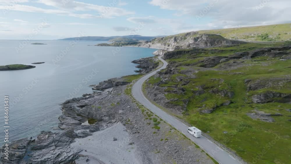 Camper van driving on a winding road in summer in Northern Norway Camper van driving on a winding road in summer in Northern Norway