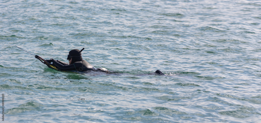 Fototapeta premium Underwater hunter preparing to dive. Fishing on sea
