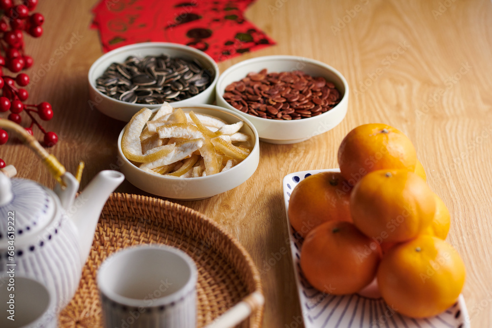 Small bowls with seeds and candied fruits prepared as treats to have with tea