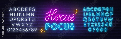 Hocus Pocus  neon lettering on brick wall background
