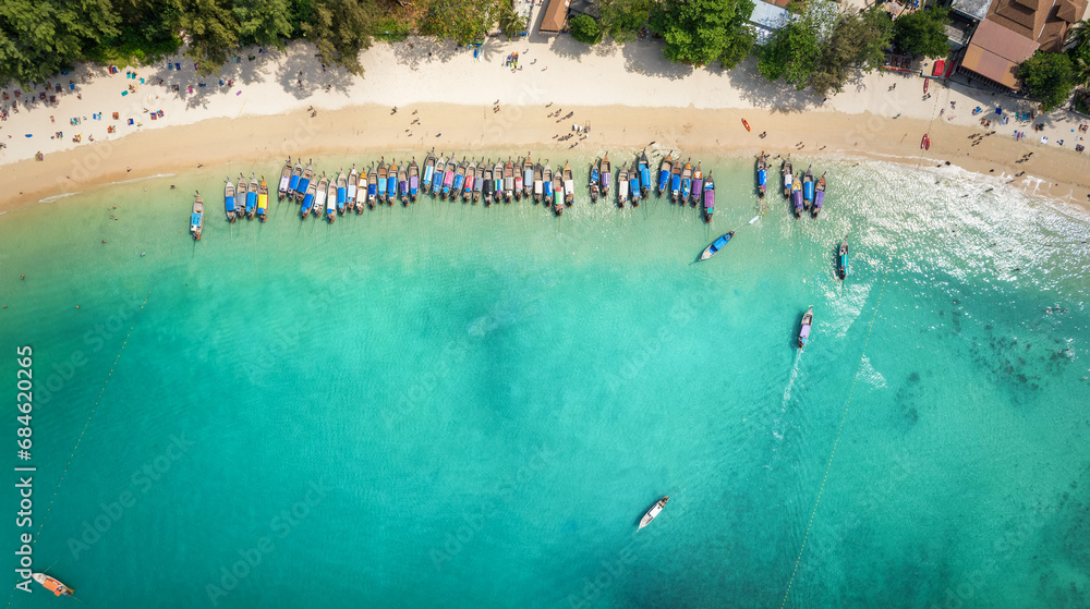 Aerial top view of the lined up long tail excursion boats at the beautiful Railay (Rai Leh) beach, Krabi, Thailand