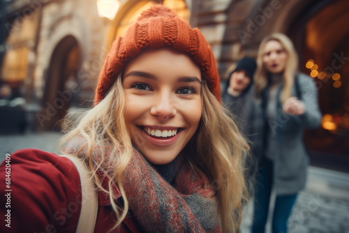 Happy woman taking selfie with her friends  in blurred background photo