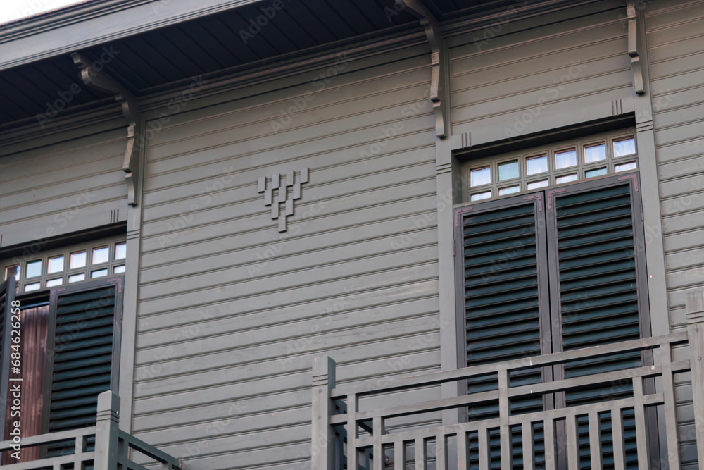 restored wooden house with grilled windows and balcony restored wooden house with grilled windows and balcony