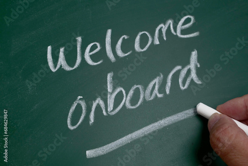 Photography Welcome onboard text on chalkboard, business metaphor