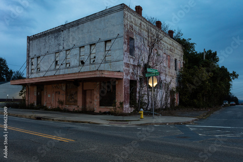 Abandoned vintage two story building on corner left forgotten photo