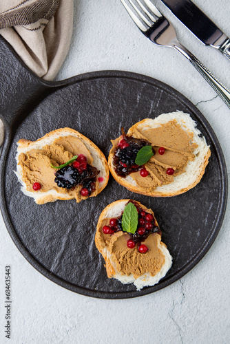 canapes with pate, mint leaves and berries, top view