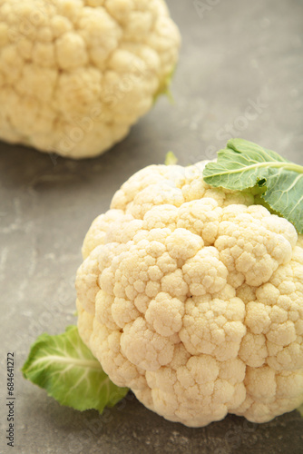 Fresh organic cauliflower on grey background. Vertical photo
