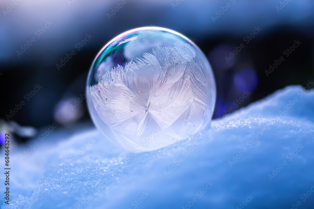 Frozen soap bubble in the snow on a frosty day Frozen soap bubble in the snow on a frosty day