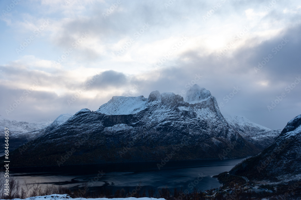 Snowy mountain hike up Segla in Senja, Norway.  Snowcapped mountains in the Arctic Circle of Northern Norway.  Famous hike on Senja island.  Shot in October
