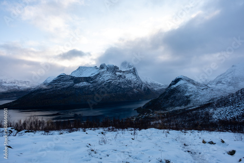 Snowy mountain hike up Segla in Senja, Norway. Snowcapped mountains in the Arctic Circle of Northern Norway. Famous hike on Senja island. Shot in October