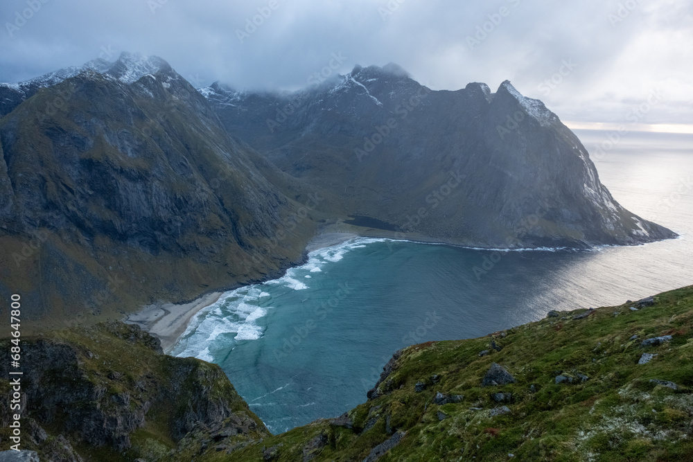 Obraz premium Kvalvika Beach at sunset in Lofoten, Norway in the Arctic Circle. One of Norway's most beautiful beaches. with tower cliffs and large waves.