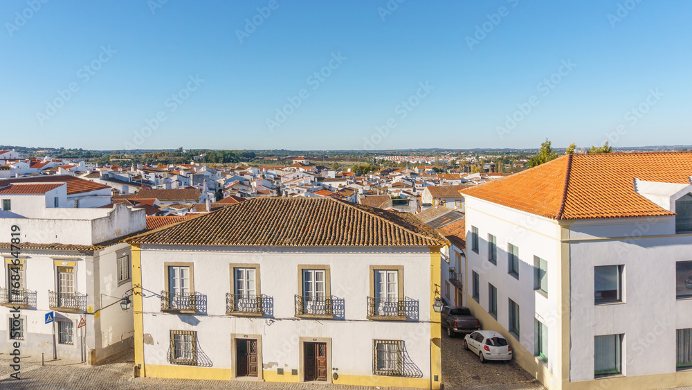 View over clay bricks roof tops the with clear blue sky on a sunny day of old town of Evora, Alentejo, Portugal