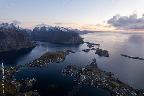 Aerial of Reinebringen mountain hike in Lofoten, Norway at sunrise / sunset.  Snowcovered mountains captured on image by a drone.  Located far North in the Arctic Circle. photo
