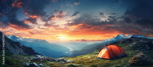 Colorful evening sky seen from a mountain campsite where travelers enjoy an adventurous vacation copy space image © vxnaghiyev