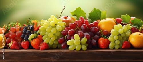 Close up of fresh ripe green grapes strawberries and tangerines copy space image