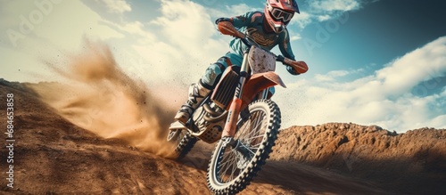 Blur motion shot of a professional motocross driver on his FMX motorcycle navigating a challenging off road track copy space image photo