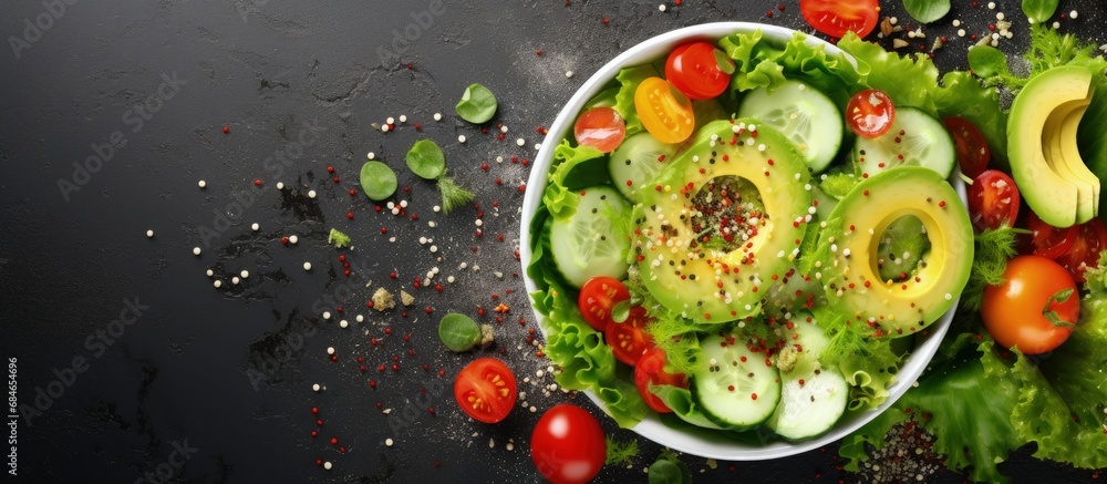 Chicken salad with fresh greens vegetables and sesame seeds viewed from above copy space image