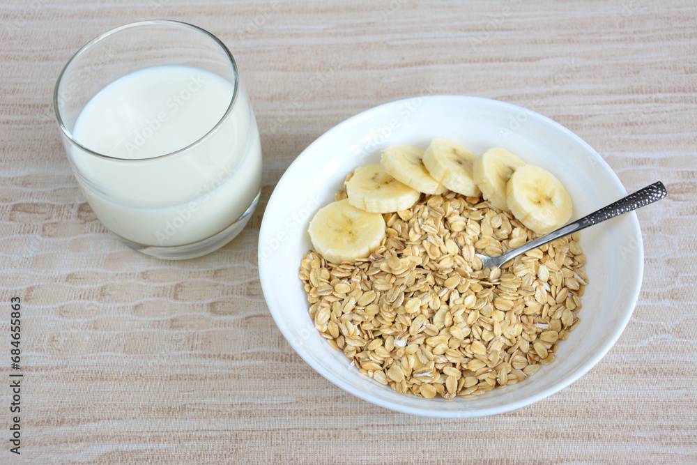 oatmeal with banana slices and spoon top view oatmeal with banana slices and spoon top view