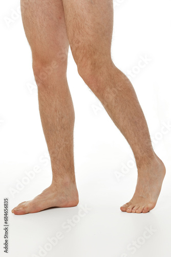 Barefoot male legs on white background. Body care concept.