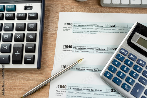 pen caluclator 1040 tax form on office desk, accounting concept photo