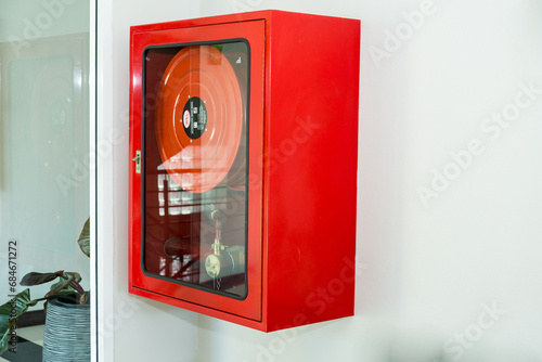 Fire Safety Concept, Fire extinguisher cabinet on gray wall for building security in hotel..