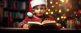 Christmas reading, Festive Reads. Kid Boy read book near Christmas tree at cozy home lights at night. Christmas Books For All The Family. Best Holiday and Christmas Books for kids.