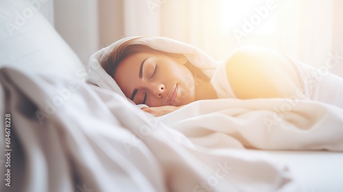 Pretty Caucasian woman sleeps calmly under blanket on soft bed at home closeup