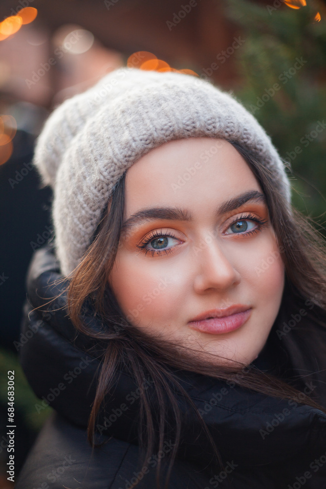 Beautiful young woman with dark hair happy at a European Christmas market. Holidays. New Year. Winter vacation. Beautiful young woman with dark hair happy at a European Christmas market. Holidays. New Year. Winter vacation.
